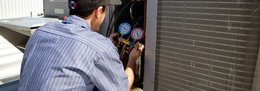 HVAC technician servicing a condenser unit in Innsbrook